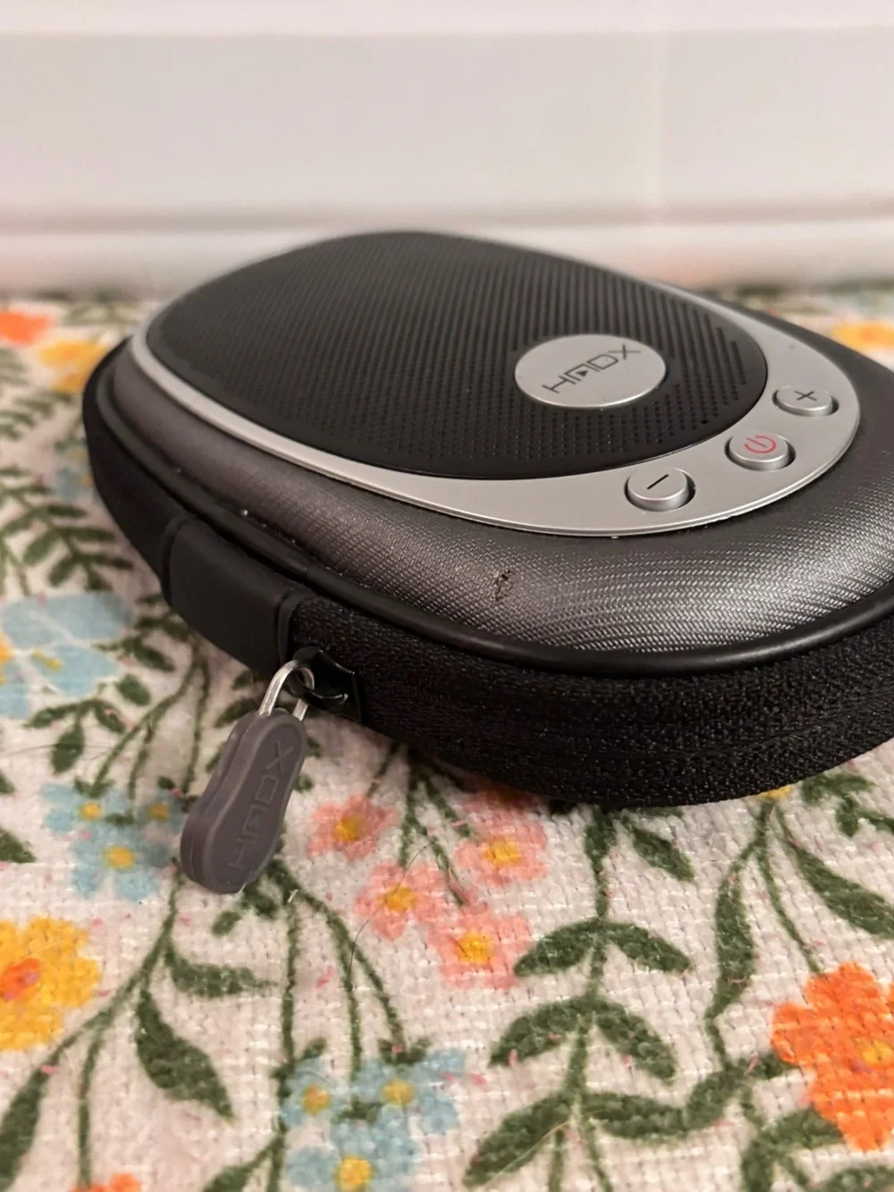 HMDX HX-G03 portable speaker featuring a black fabric grill and silver accents